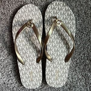Michael Kors gold flip flops